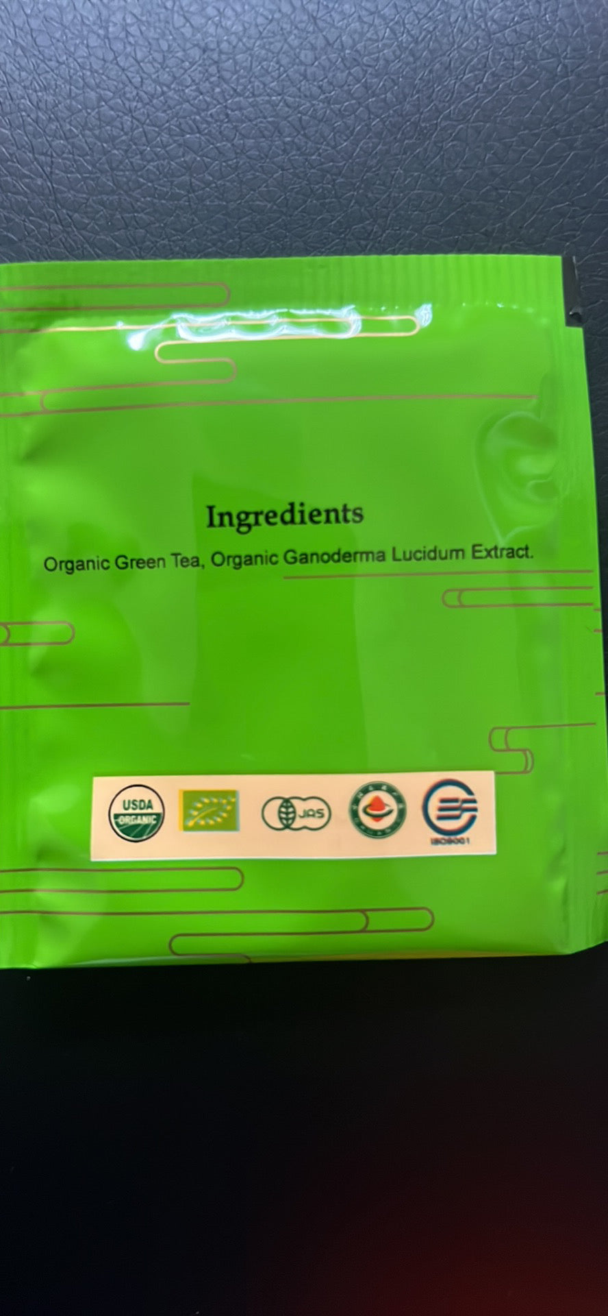Back of the green tea packet showing ingredients: organic green tea and organic Ganoderma lucidum extract
